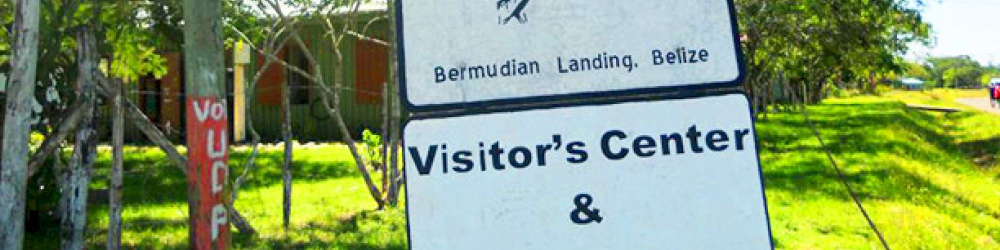 A sign at the Community Baboon Sanctuary in Bermudian Landing, Belize, indicates the Visitor's Center and Museum hours from 8 a.m. to 5 p.m.