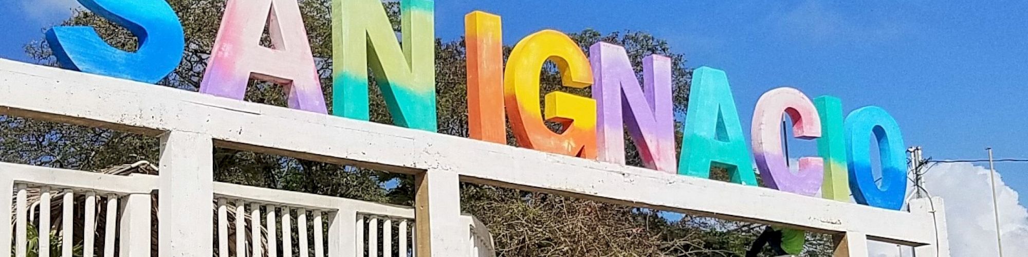 The image shows a colorful sign that reads 