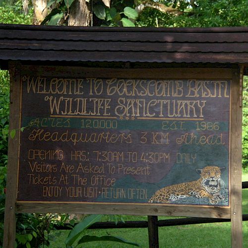 This image shows a sign for Lerkson Basin Wildlife Sanctuary, detailing opening hours, area size, establishment year, and a cheetah illustration.
